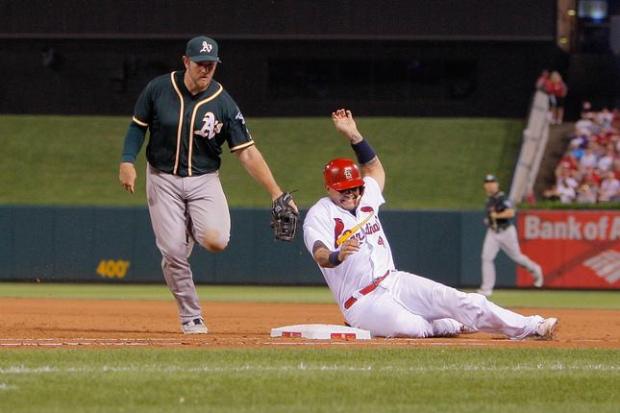 ST. LOUIS, MO - AUGUST 26: Yadier Molina #4 of the St. Louis Cardinals is tagged out by Max Muncy #12 of the Oakland Athletics during the sixth inning of a baseball game at Busch Stadium on August 26, 2016 in St. Louis, Missouri. (Photo by Scott Kane/Getty Images)