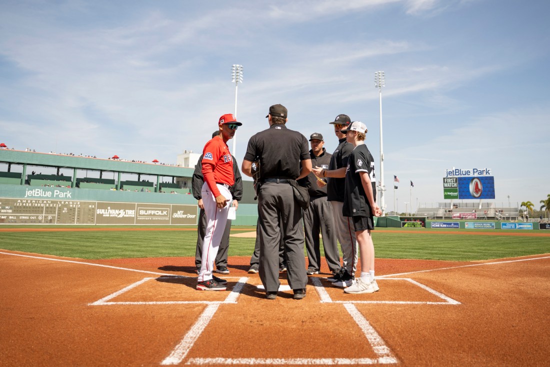 Red Sox manager Alex Cora and Northeastern coach Mike Glavine meet at home plate before the spring training game at JetBlue Park.
