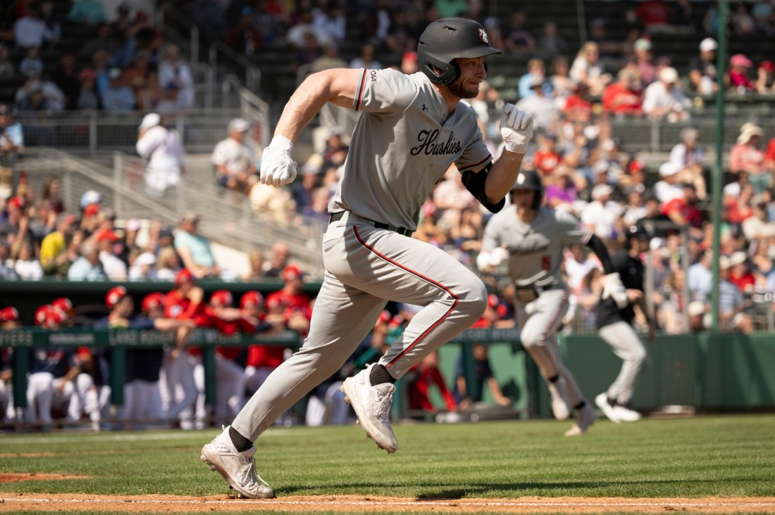 Northeastern baseball player in mid-pitch during the spring training exhibition game against the Red Sox in Fort Myers, Florida.