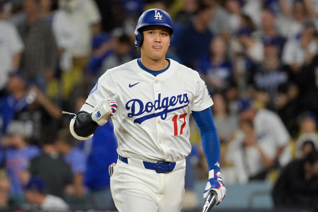 Los Angeles Dodgers designated hitter Shohei Ohtani (17) reacts after flying out against the Cincinnati Reds in the fourth inning during game two of the Wildcard round for the 2025 MLB playoffs at Dodger Stadium. 