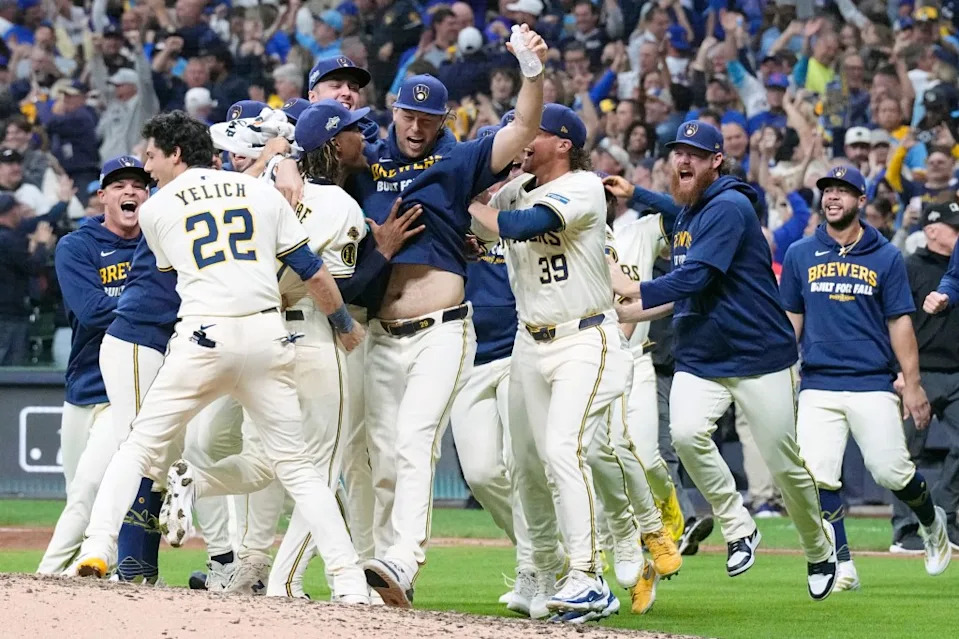 Christian Yelich (22) and pitcher Abner Uribe (45) celebrate with teammates after the Brewers’ 3-1 win over the Cubs in Game 5 of the NLDS in Milwaukee. Michael McLoone-Imagn Images
