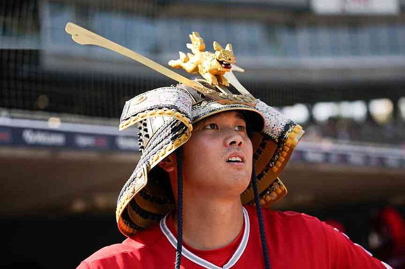 FILE - Los Angeles Angels' Shohei Ohtani celebrates wearing a Kabuto samurai warrior helmet after his home run against the Detroit Tigers during the fourth inning in the second baseball game of a doubleheader, Thursday, July 27, 2023, in Detroit. (AP Photo/Paul Sancya, File)