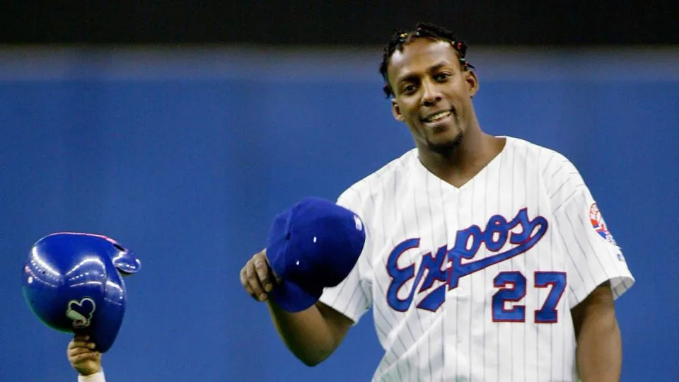 Vladimir Guerrero Sr. when he was playing for the Montreal Expos and his son Vladimir Jr. tip their caps to the crowd on September 29, 2002 in Montreal. - Paul Chiasson/AP