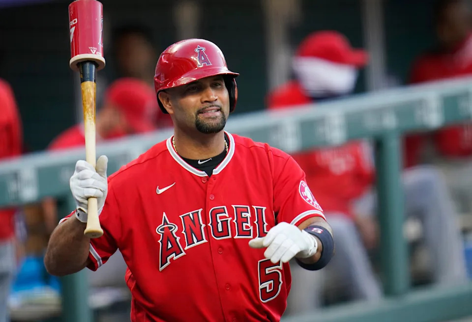 FILE - Los Angeles Angels designated hitter Albert Pujols waves to players in the Colorado Rockies dugout in the second inning of a baseball game, Sept. 12, 2020, in Denver. (AP Photo/David Zalubowski, File)