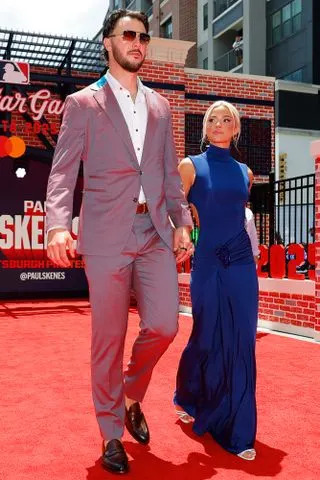 Todd Kirkland/MLB Photos via Getty Paul Skenes and Livvy Dunne walk the 2025 All-Star red carpet.