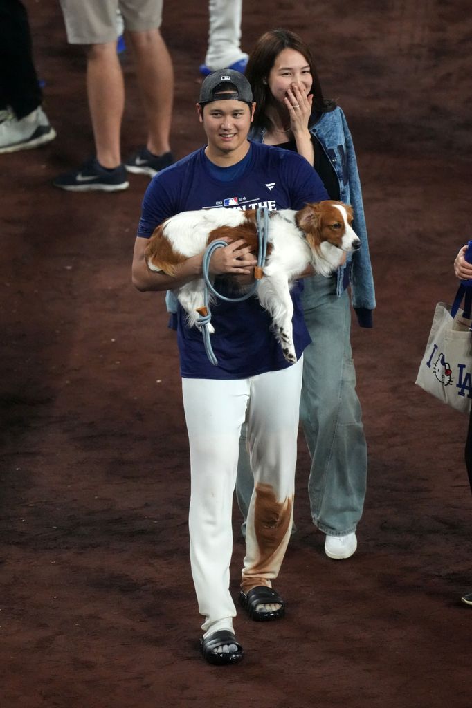 Shohei Ohtani, his dog Decoy and his wife Mamiko Tanaka after a baseball game