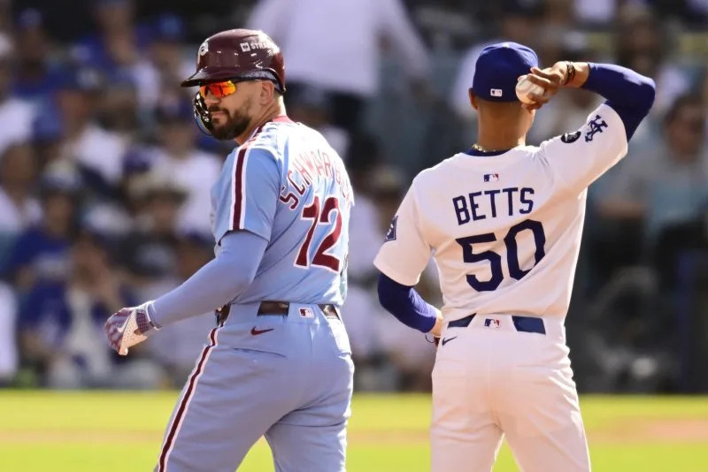 Philadelphia Phillies designated hitter Kyle Schwarber (L) stands on second base after hitting a double in the first inning as Los Angeles Dodgers infielder Mookie Betts handles the ball in Game 4 of the National League Division Series on Thursday at Dodger Stadium in Los Angeles. Photo by John McCoy/UPI