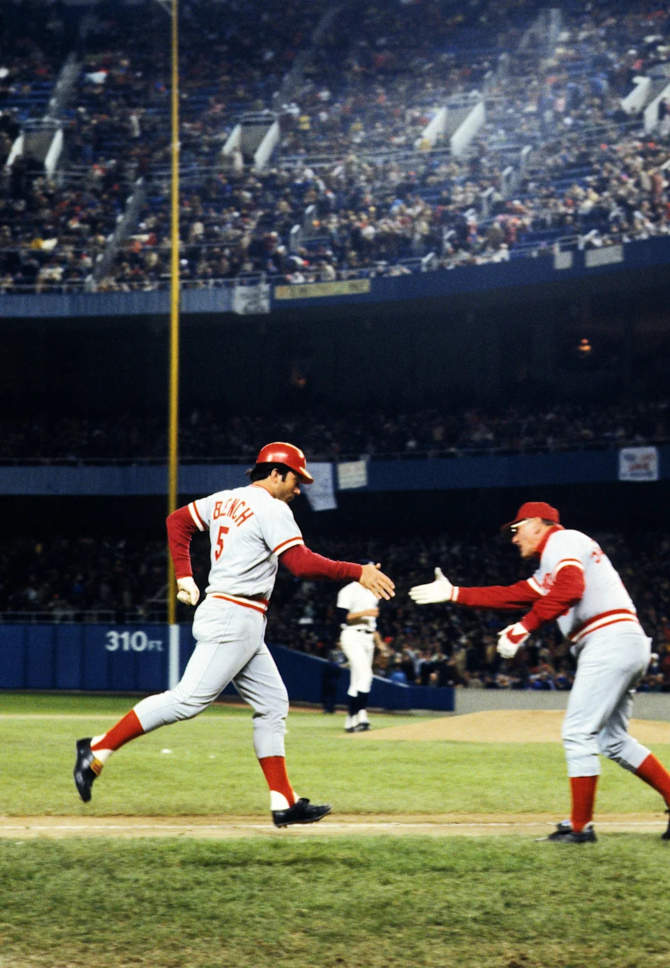 Oct 21, 1976; Bronx, NY, USA; FILE PHOTO; Cincinnati Reds catcher Johnny Bench (5) is congratulated by third base coach George Scherger after hitting one of his two home runs against the New York Yankees during game four of the 1976 World Series at Yankee Stadium. Cincinnati defeated New York 7-2 to win the World Series in four games and Johnny Bench was named the series most valuable player. Mandatory Credit: Dick Raphael-USA TODAY Sports