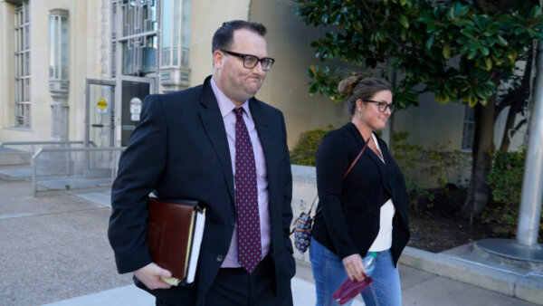 Eric Kay, left, walks out of a federal court