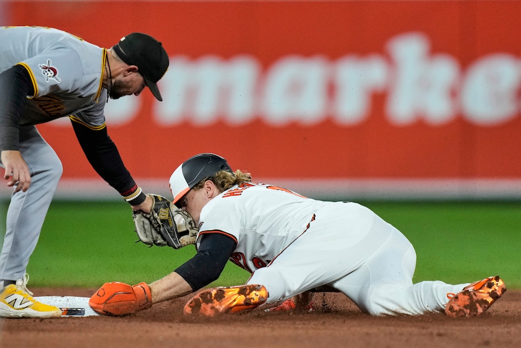 Baltimore Orioles' Gunnar Henderson, right, steals second base past Pittsburgh Pirates shortstop Jared Triolo, left, during the fourth inning.