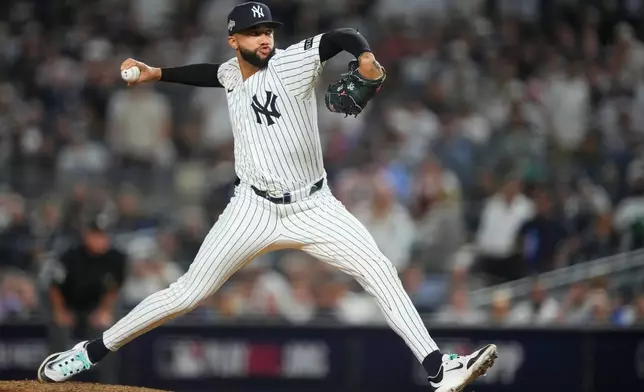 New York Yankees pitcher Devin Williams delivers against the Toronto Blue Jays during the seventh inning of Game 3 of baseball's American League Division Series, Tuesday, Oct. 7, 2025, in New York. (AP Photo/Yuki Iwamura)