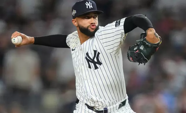 New York Yankees pitcher Devin Williams delivers against the Toronto Blue Jays during the seventh inning of Game 3 of baseball's American League Division Series, Tuesday, Oct. 7, 2025, in New York. (AP Photo/Yuki Iwamura)