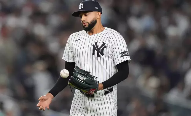 New York Yankees pitcher Devin Williams reacts after giving up a two-run RBI single to Toronto Blue Jays' Nathan Lukes during the seventh inning of Game 4 of baseball's American League Division Series, Wednesday, Oct. 8, 2025, in New York. (AP Photo/Frank Franklin II)