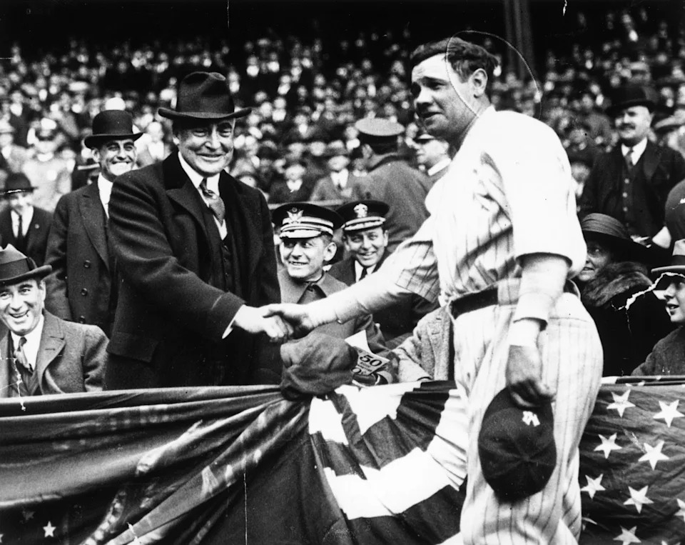 Great all-round baseball player, Babe Ruth (George Herman Ruth, 1895 - 1948) shakes hands with the 29th President of the USA, Warren Harding. After the handshake Babe Ruth hit a home run to help his team, the New York Yankees win the third game of the series.