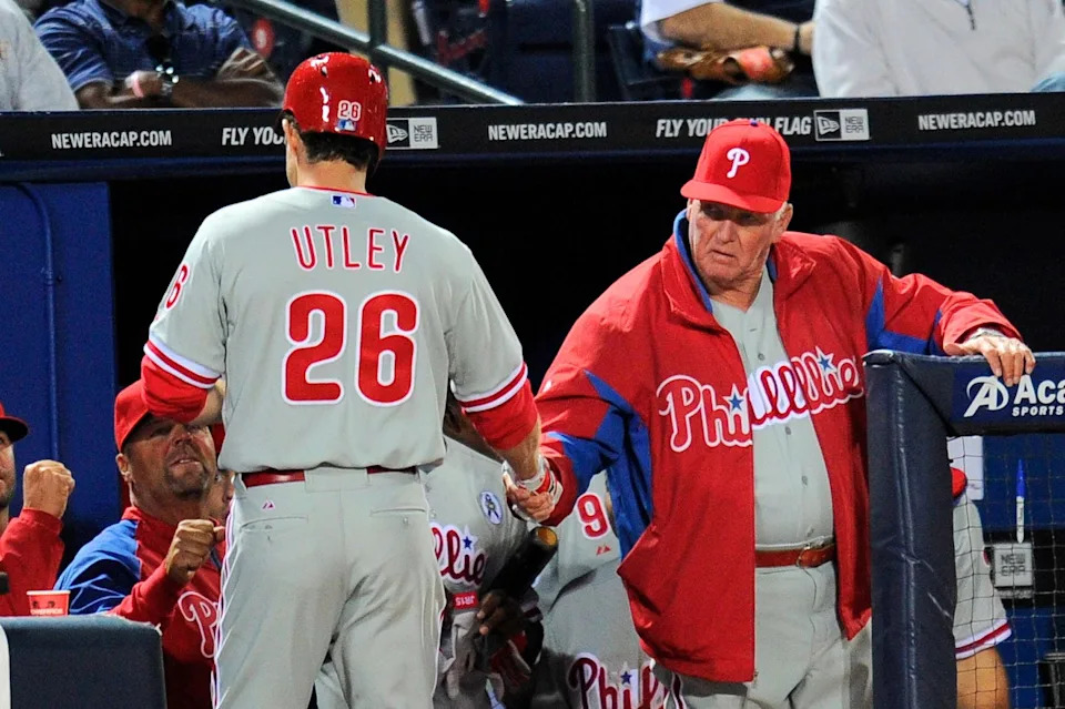 Philadelphia Phillies second baseman Chase Utley (26) shakes hands with manager Charlie Manuel (41) after hitting a home run against the Atlanta Braves during the fourth inning at Turner Field.