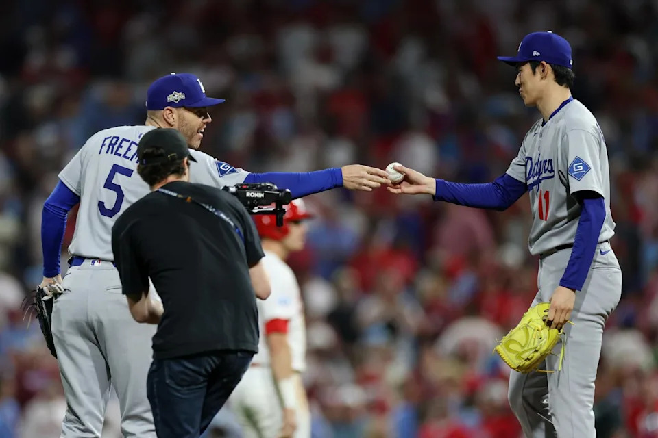 Dodgers first baseman Freddie Freeman gives the ball to Roki Sasaki after he closed out the ninth inning in Game 2 of NLDS.