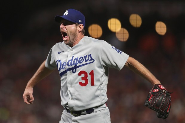 Dodgers pitcher Max Scherzer celebrates after the Dodgers defeated the San Francisco Giants in Game 5 of a baseball National League Division Series Thursday, Oct. 14, 2021, in San Francisco. (AP Photo/Jed Jacobsohn)