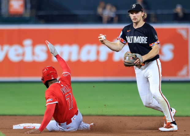 Baltimore Orioles shortstop Gunnar Henderson, right, forces out the Angels’...