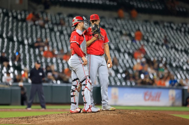 Angels relief pitcher Brock Burke, right, meets with catcher Logan...