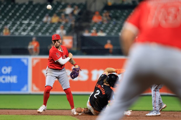 Angels shortstop Zach Neto turns a double play in the...