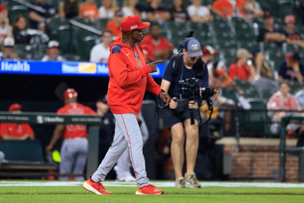 Angels manager Ron Washington signals to the bullpen as he...