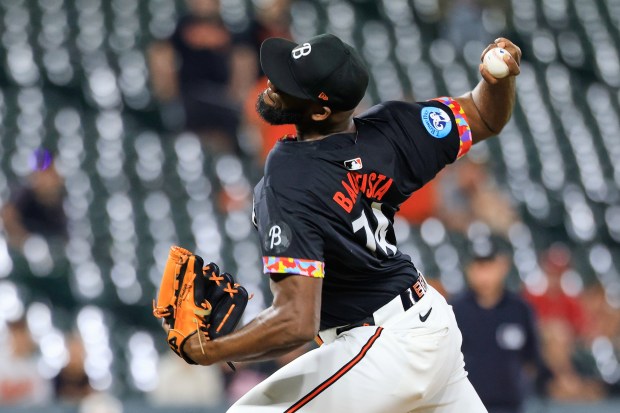 Baltimore Orioles relief pitcher Félix Bautista throws to the plate...