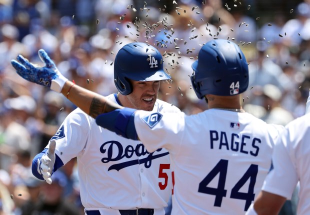 The Dodgers’ Freddie Freeman is congratulated with a sunflower seed...