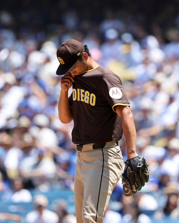 San Diego Padres starting pitcher Yu Darvish wipes his lip...