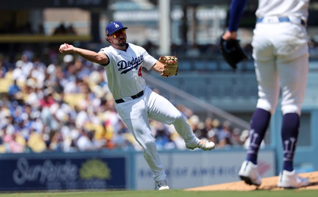 Dodgers third baseman Buddy Kennedy throws to first base against...