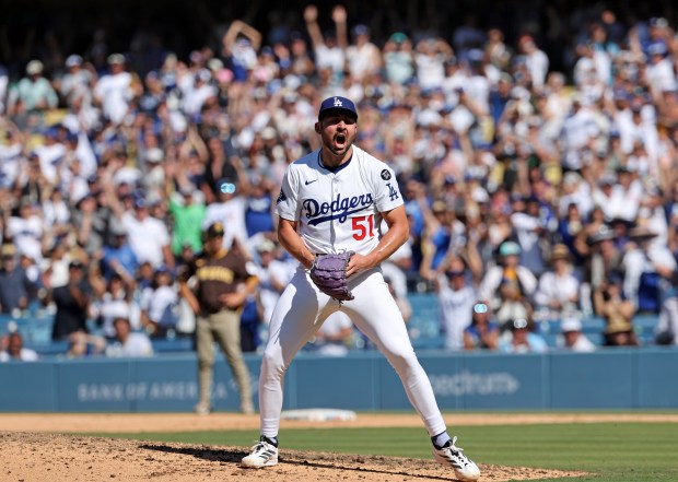 Dodgers relief pitcher Alex Vesia celebrates after striking out the...