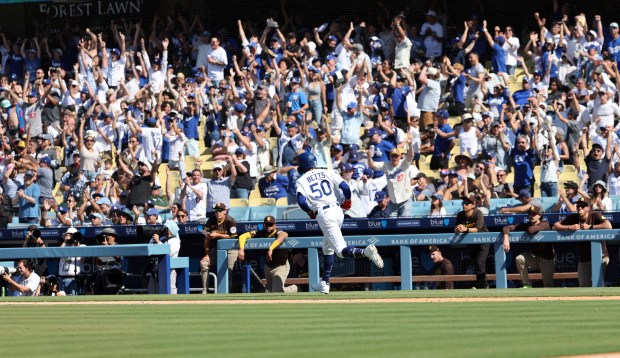 The Dodgers’ Mookie Betts celebrates as he runs the bases...