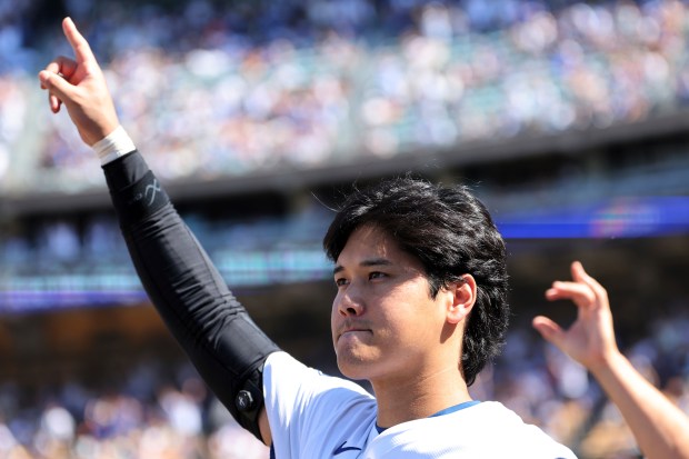 Dodgers star Shohei Ohtani celebrates after teammate Mookie Betts hit...