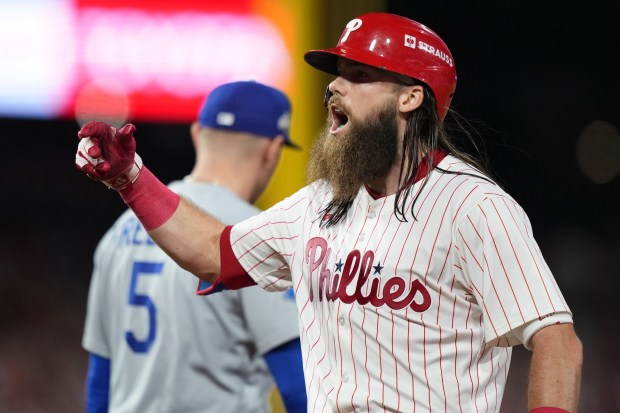 The Philadelphia Phillies’ Brandon Marsh reacts after hitting a single...