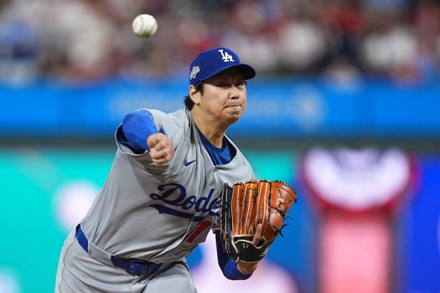 Dodgers starting pitcher Shohei Ohtani throws to the plate during...
