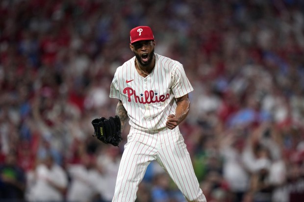 Philadelphia Phillies pitcher Cristopher Sánchez reacts after striking out Los...