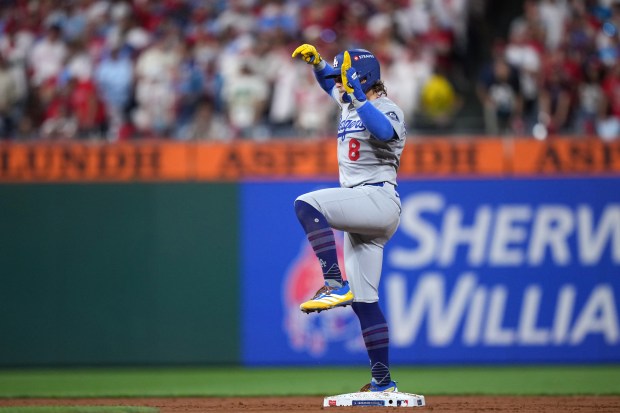 The Dodgers’ Kike Hernandez celebrates at second base after hitting...