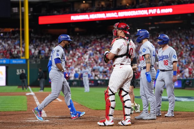 The Dodgers’ Teoscar Hernández, left, who hit a go-ahead three-run...