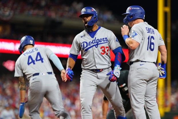 The Dodgers’ Teoscar Hernández, center, celebrates with teammate Will Smith,...