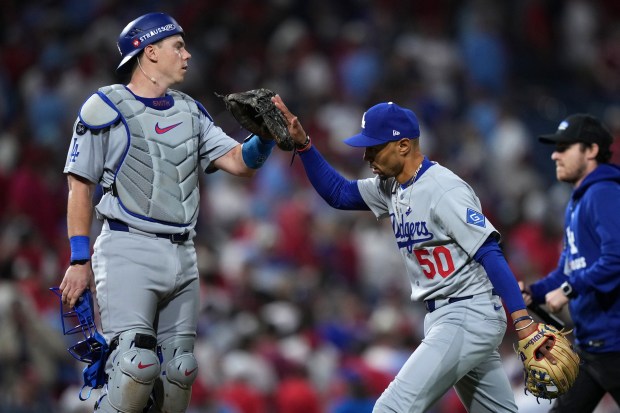 Dodgers catcher Will Smith, left, and shortstop Mookie Betts celebrate...