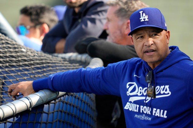 Dodgers manager Dave Roberts watches batting practice before Game 4...