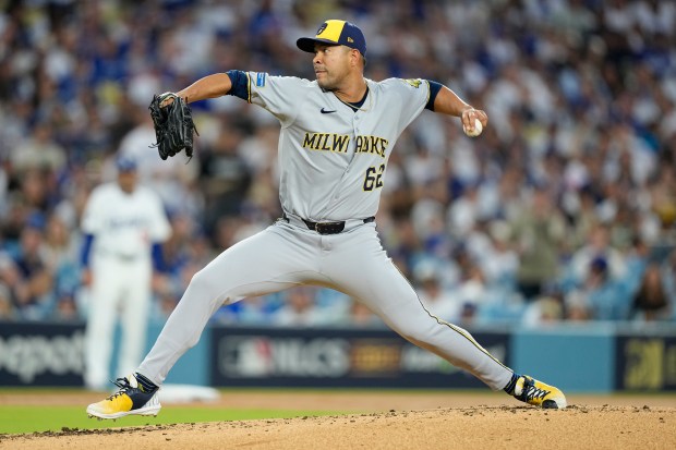 Milwaukee Brewers starting pitcher Jose Quintana throws to the plate...