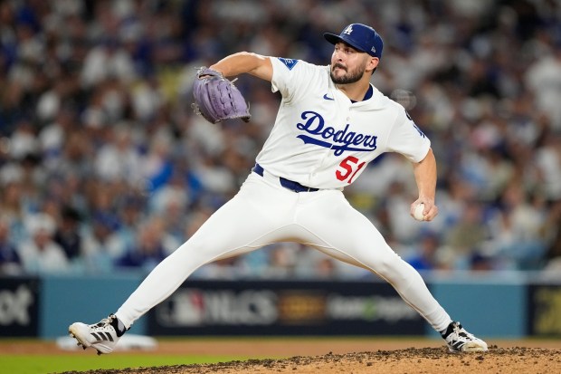 Dodgers relief pitcher Alex Vesia throws to the plate throws...