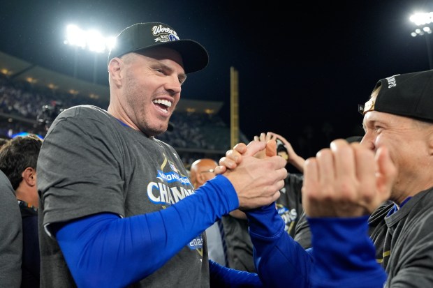 Dodgers first baseman Freddie Freeman, left, celebrates on the field...