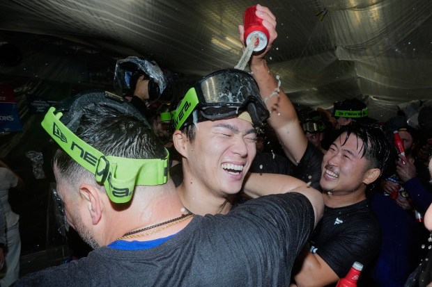 Dodgers pitcher Yoshinobu Yamamoto celebrates their win against the Milwaukee...