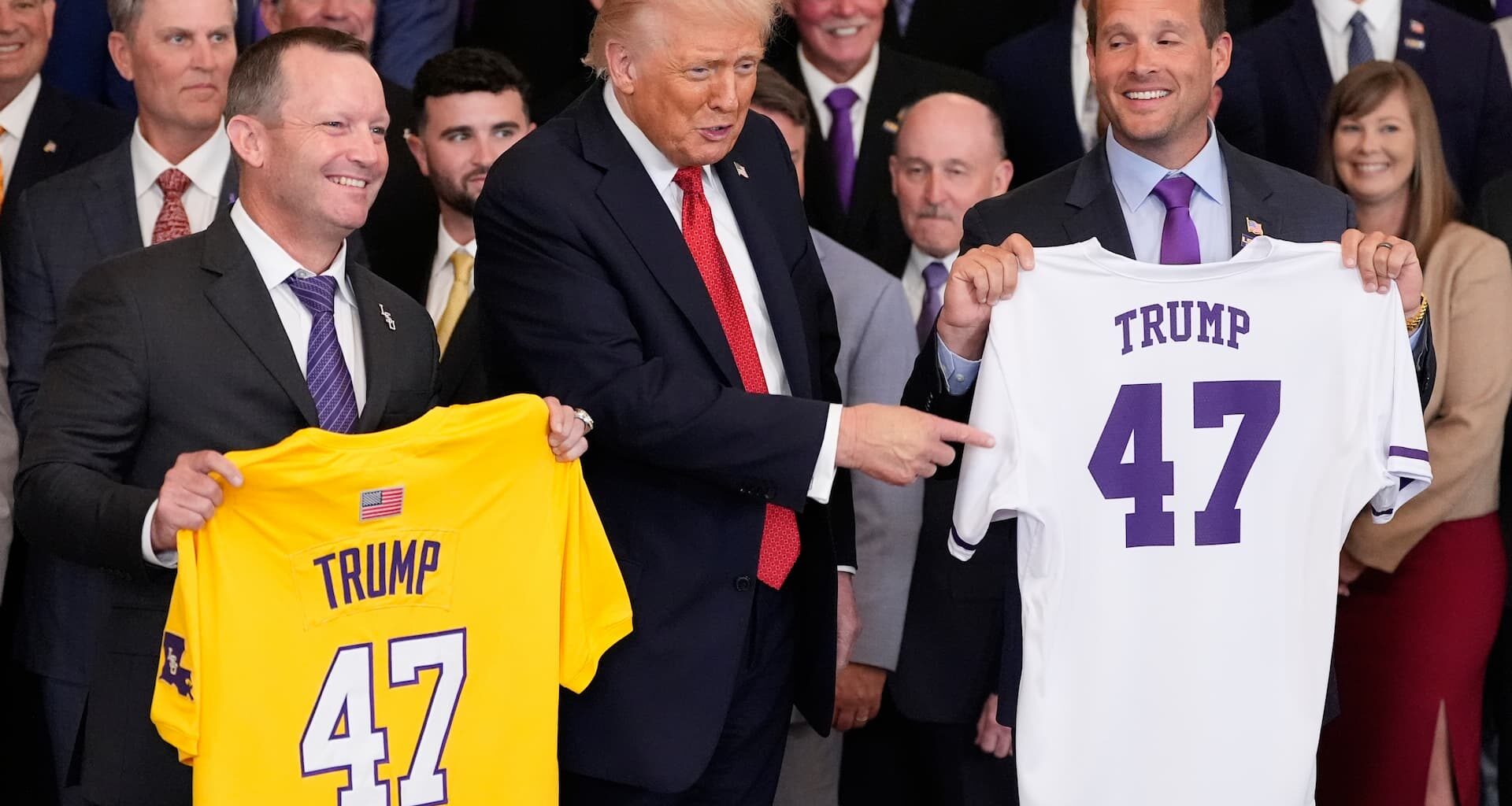 Title: Trump Image ID: 25293767925881 Article: President Donald Trump poses with the teams and LSU coach Jay Johnson, left, and LSU-Shreveport coach Brad Neffendor during an event to welcome the 2025 LSU and LSU-Shreveport national champion baseball teams in the East Room of the White House, Monday, Oct. 20, 2025, in Washington. (AP Photo/Alex Brandon)