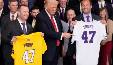 Title: Trump Image ID: 25293767925881 Article: President Donald Trump poses with the teams and LSU coach Jay Johnson, left, and LSU-Shreveport coach Brad Neffendor during an event to welcome the 2025 LSU and LSU-Shreveport national champion baseball teams in the East Room of the White House, Monday, Oct. 20, 2025, in Washington. (AP Photo/Alex Brandon)