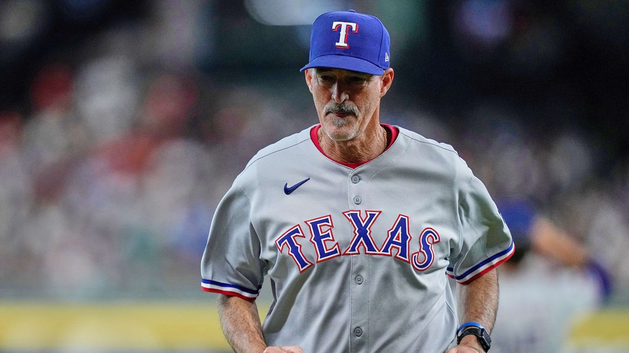 Texas Rangers pitching coach Mike Maddux (31) heads back to the dugout after a mound visit during the first inning of a baseball game against the Houston Astros, Friday, July 11, 2025, in Houston. (AP Photo/Kevin M. Cox)