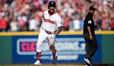 Cleveland Guardians Brayan Rocchio reacts as he rounds the bases after hitting a solo home run in the eighth inning of Game 2 of the American League Wild Card baseball playoff series against the Detroit Tigers in Cleveland, Wednesday, Oct. 1, 2025. Umpire Vic Carapazza looks on at right. (AP Photo/David Dermer)