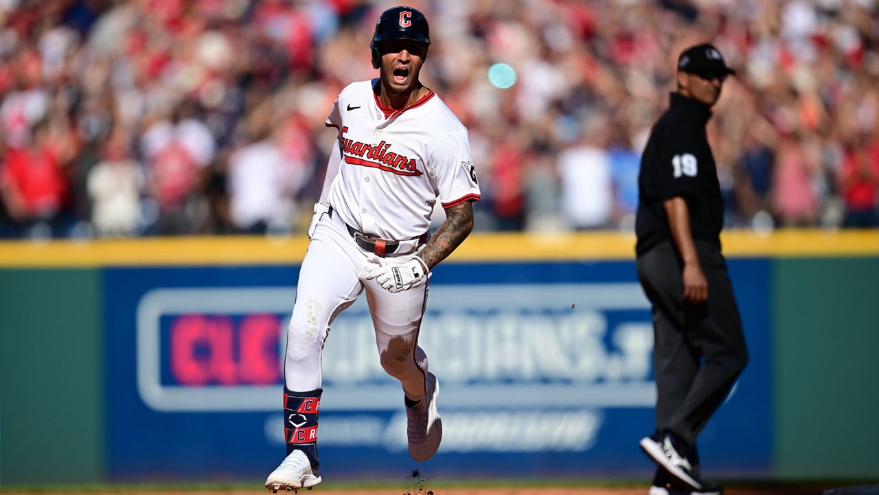 Cleveland Guardians Brayan Rocchio reacts as he rounds the bases after hitting a solo home run in the eighth inning of Game 2 of the American League Wild Card baseball playoff series against the Detroit Tigers in Cleveland, Wednesday, Oct. 1, 2025. Umpire Vic Carapazza looks on at right. (AP Photo/David Dermer)
