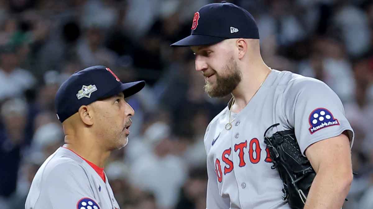 Boston Red Sox manager Alex Cora (13) shakes hands with starting pitcher Garrett Crochet (35) during a pitching change during the eighth inning of game one of the Wildcard round of the 2025 MLB playoffs against the New York Yankees at Yankee Stadium. 